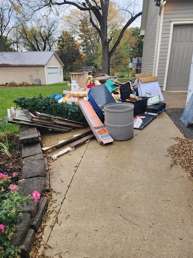 Dumpster being loaded with debris for Residential Dumpster Rental in Columbia Falls